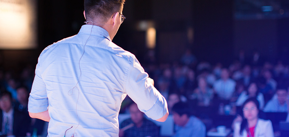 Presenter on stage at a corporate event